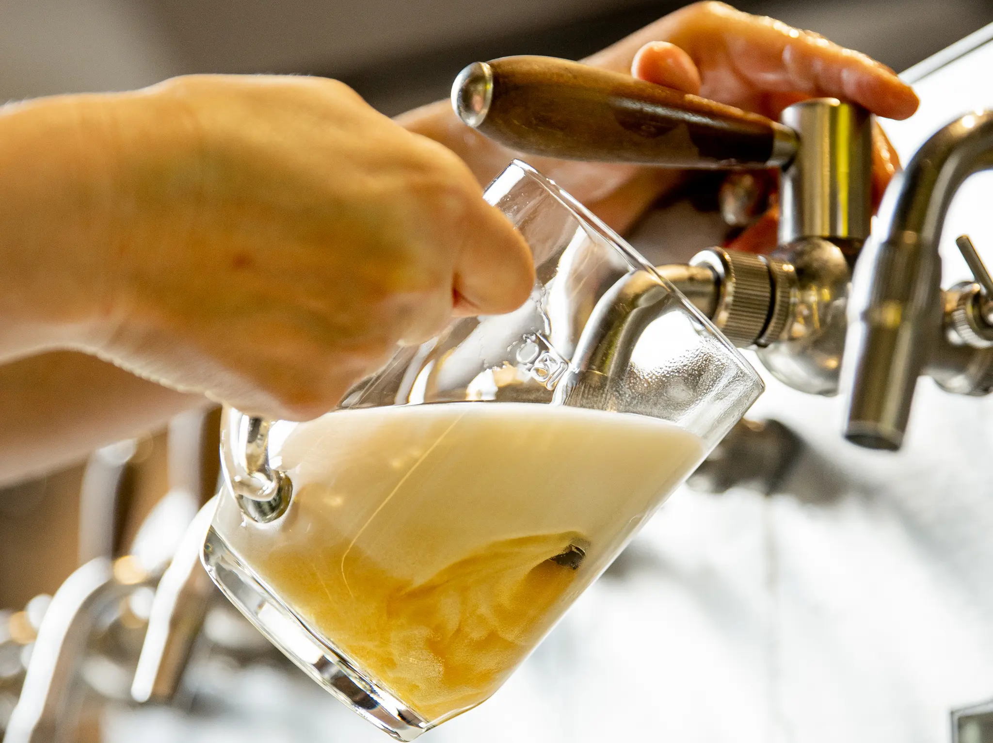 Pouring beer from a tap into a glass.