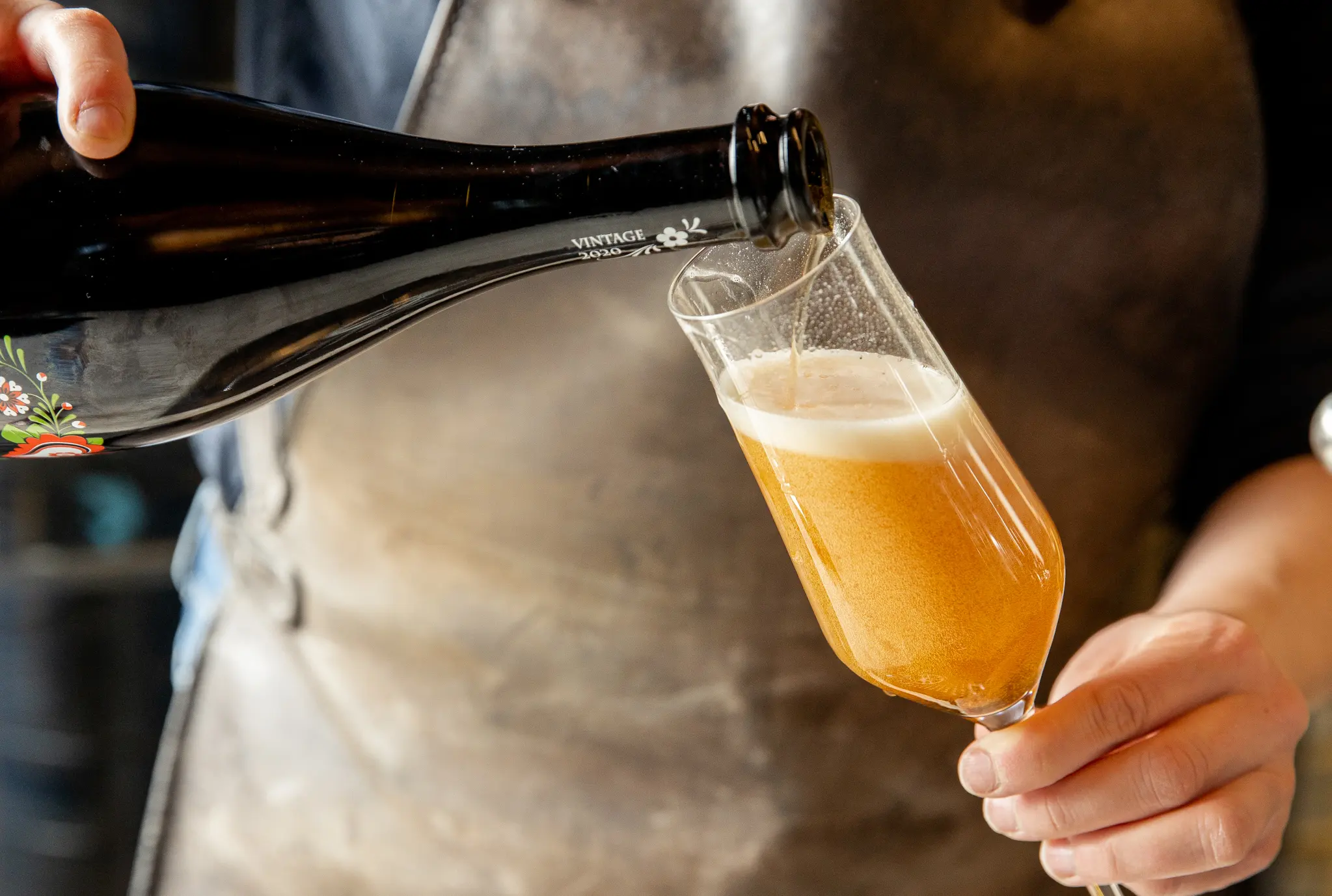 Pouring craft beer into a glass.